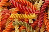 multi colored fusilli twirls pasta background