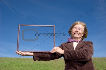 Attractive mature woman enjoying life on the meadow