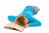 Tired teenager boy fallen asleep on his book