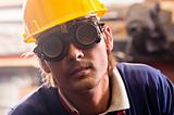 Closeup of an industrial worker in yellow helmet