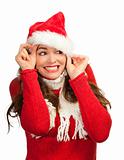 Attractive woman peeking out from santa hat