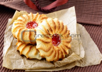 beautiful cookies with jam on a brown background