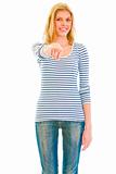 Cheerful teen girl pointing finger on you
