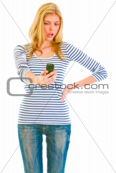 Surprised teen girl looking on mobile phone
