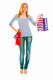 Full length portrait of happy teen girl with shopping bags
