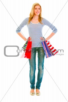 Full length portrait of smiling teen girl with shopping bags
