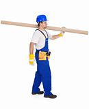 Handyman or worker carrying pipe section