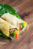 tortilla filled with chicken meat and vegetables