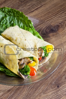 tortilla filled with chicken meat and vegetables