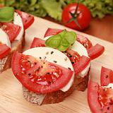 Fingerfood with mozzarella cheese and tomatos