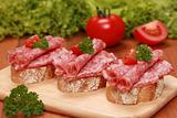 Fingerfood with salami and tomatos