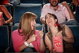 Women Laugh in a Theater