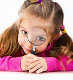 girl looking through a magnifying glass