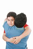 Portrait of a young boy hugging his father against white backgro