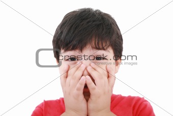 Preschool aged boy with his hands over his mouth