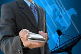 businessman hand holding mobile phone and satellite dish antennas