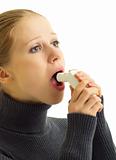 young  woman holding asthma inhaler