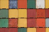 Colorful ship cargo containers stacked up in a port.