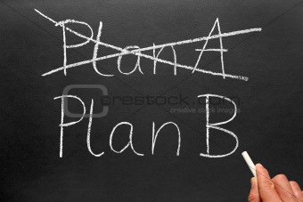 Crossing out Plan A and writing Plan B on a blackboard.