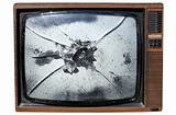 An old trashed TV with a smashed screen.