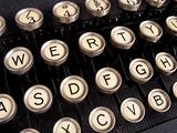 Close up of keys on a dirty old nicotine stained typewriter.