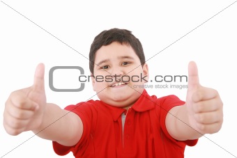 Thumbs up shown by a happy young boy 