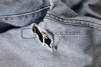 Hole in an old pair of blue jeans