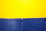 Blue jeans with yellow background