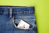 Joker playing card in blue jeans pocket