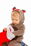 Curious cute baby examines Christmas sock
