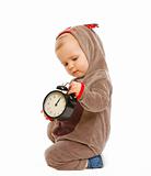 Adorable baby in costume of Santa Claus's reindeer with alarm clock

