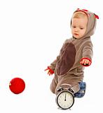 Cute baby playing with alarm clock and Christmas ball
