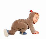 Curious baby in costume of Santa Claus's reindeer crawling
