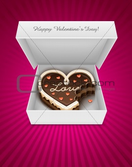 Open box with nibbled chocolate cake in heart form