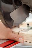 Labor safety - man cutting finger with power tool