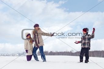 Kids and woman enjoy the snow