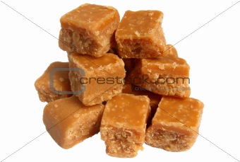 A pile of sweet butter fudge pieces isolated over white