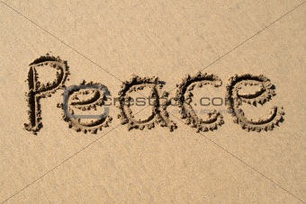 Peace, written on a sandy beach.