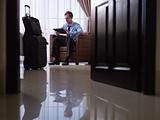 Businessman using digital tablet pc in hotel room 