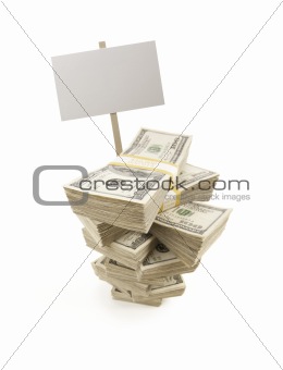 Stacks of One Hundred Dollar Bills with Blank Sign Isolated on a White Background.