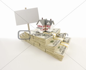 Stacks of One Hundred Dollar Bills with Small House and Blank Sign on Slight Gradation.