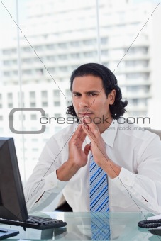 Portrait of a businessman thinking while looking at the camera