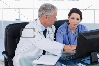 Medical team working together with a computer