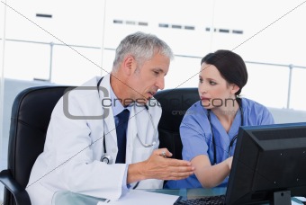 Serious medical team working with a computer