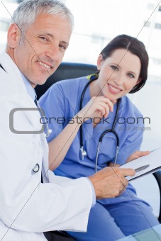 Portrait of a smiling medical team looking a document