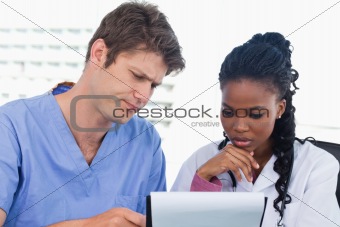 Doctors looking at a document