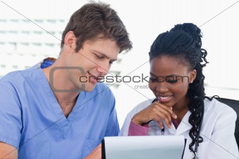 Happy doctors looking at a document