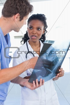 Portrait of young doctors looking at a of X-ray