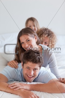 Portrait of a happy family lying on each other