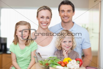 Family standing in kitchen